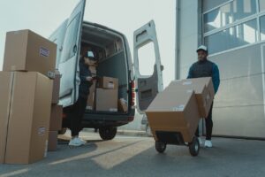 delivery truck and workers delivering packages